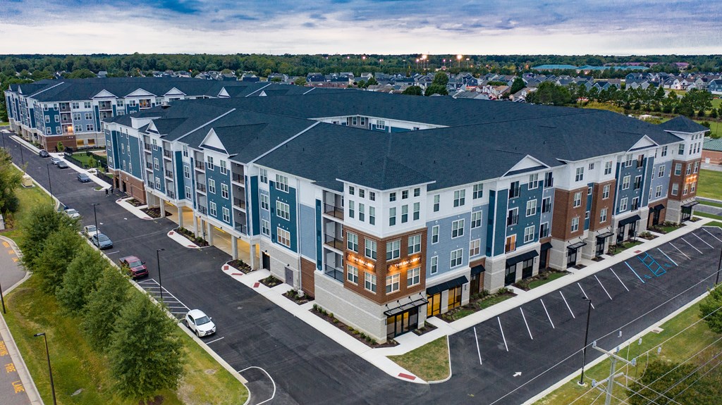 an aerial view of an apartment building on a city street