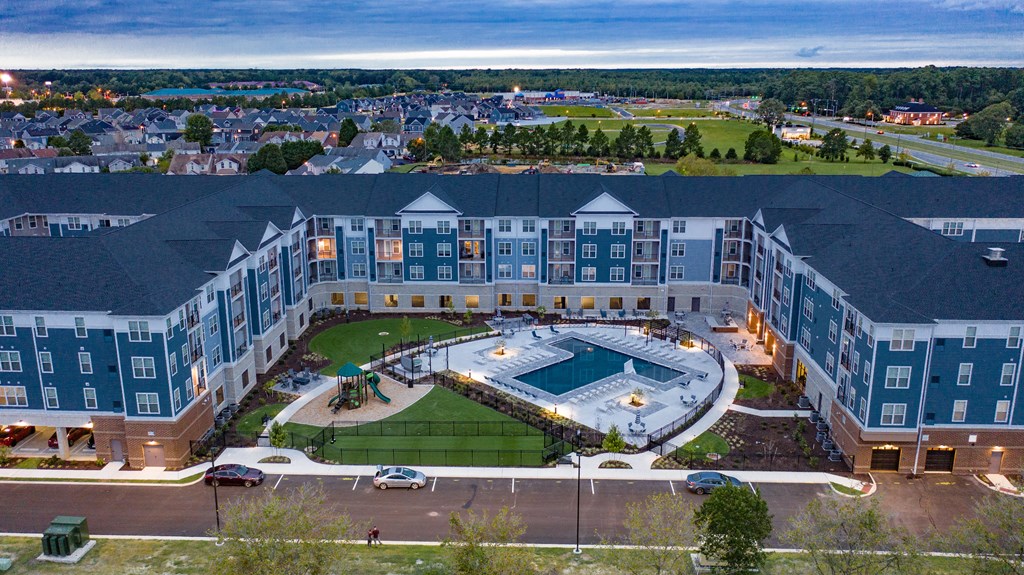 an aerial view of a large building with an outdoor pool