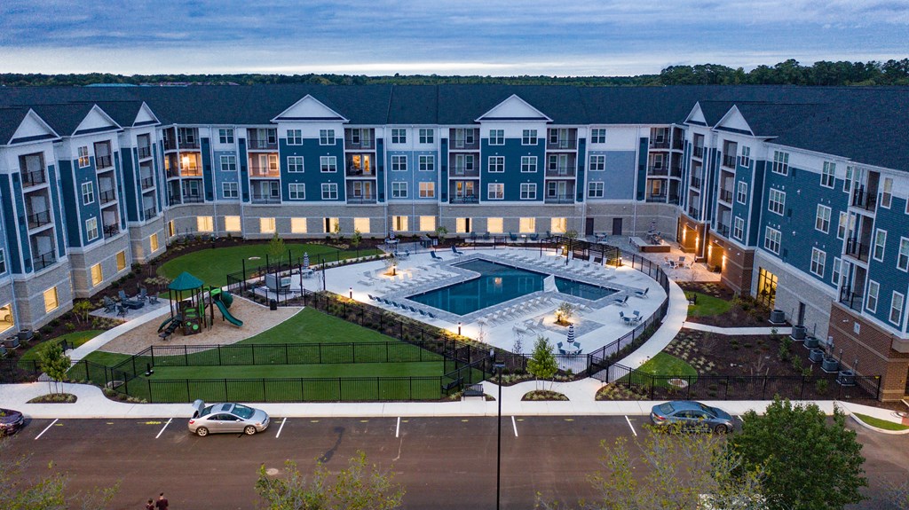 an aerial view of a large building with an outdoor pool