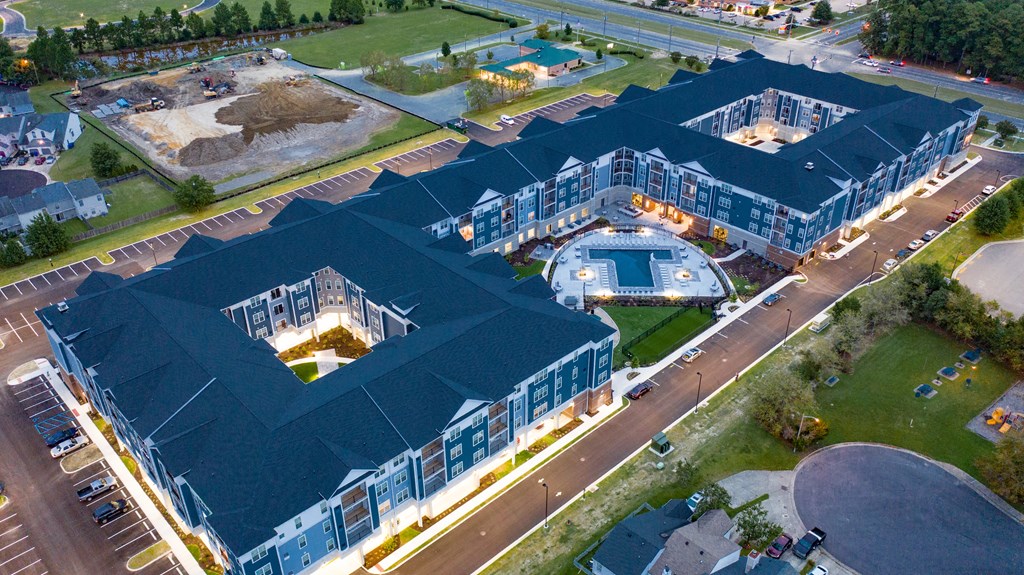 an aerial view of an office building and a parking lot