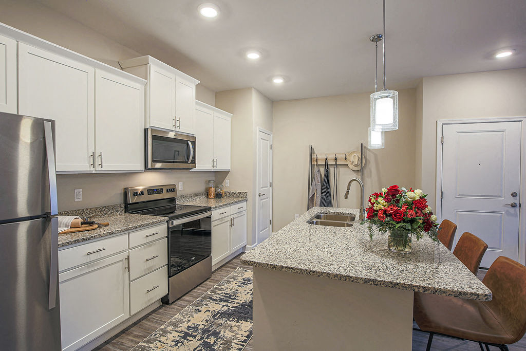 a kitchen with white cabinets and a counter top
