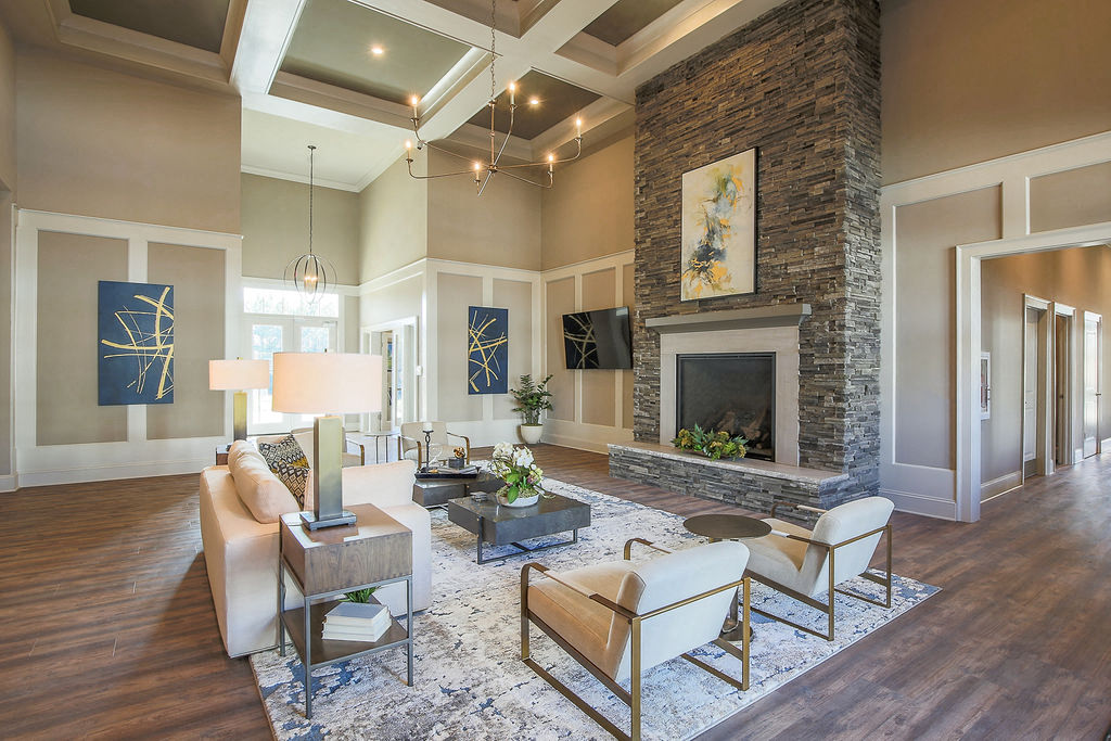 a living room with a stone fireplace and furniture
