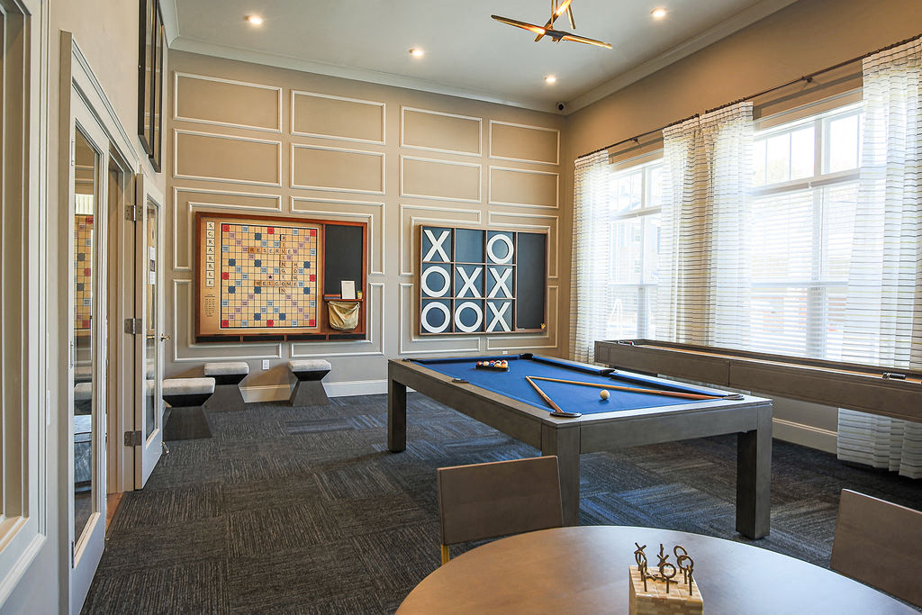 a games room with a pool table and a painting