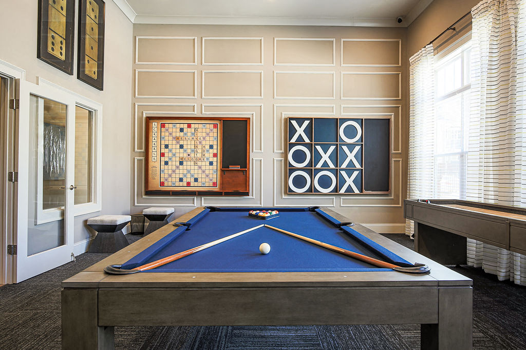 a games room with a pool table and a scoreboard