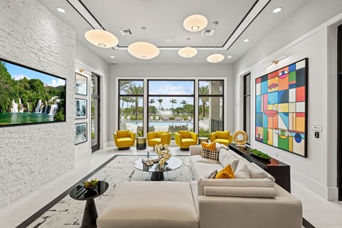 a living room with white walls and yellow furniture and a large window