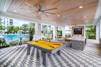 a pool room with a pool table and a bar at Altis Grand Kendall, Miami, FL