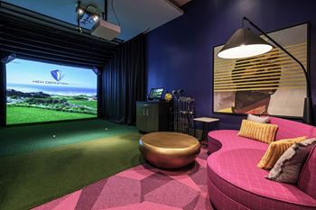 a game room with a pink couch and a view of the golf course at Altis Grand Kendall, Miami, FL 33186