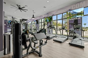 a gym with cardio machines and a view of the beach at Altis Grand Kendall, Miami Florida