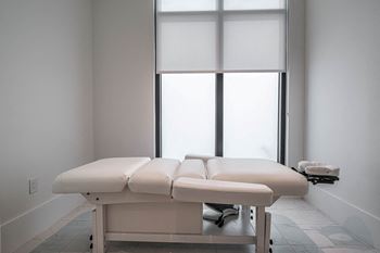 a spa room with two massage tables and two windows at Altis Grand Kendall, Florida, 33186