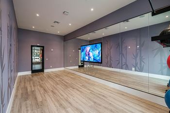 a large room with mirrored walls and a tv in the middle at Altis Grand Kendall, Florida