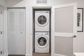 a small laundry room with a washing machine and a dryer at Altis Grand Kendall, Miami