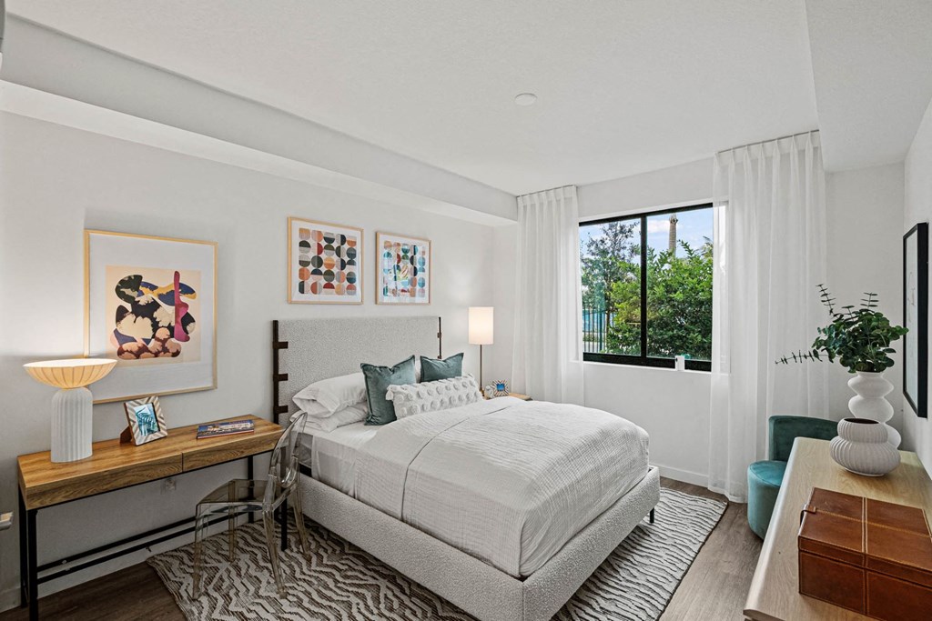 a bedroom with a bed and a window a bedroom with a bed and a window at Altis Grand Kendall, Miami, FL