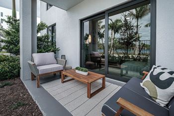 a patio with two chairs and a coffee table at Altis Grand Kendall, Miami, 33186