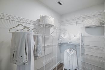 a large walk in closet with white clothing and pillows at Altis Grand Kendall, Miami, 33186