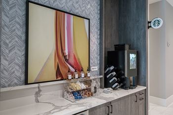 a bathroom with a mirror and a coffee machine on a counter at Altis Grand Kendall, Miami Florida