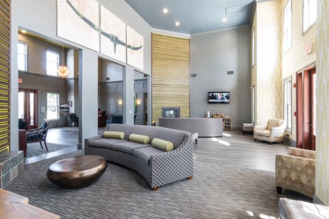 A living room with a grey sofa and a wooden coffee table.