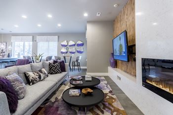 a living room with a couch and a coffee table and a television