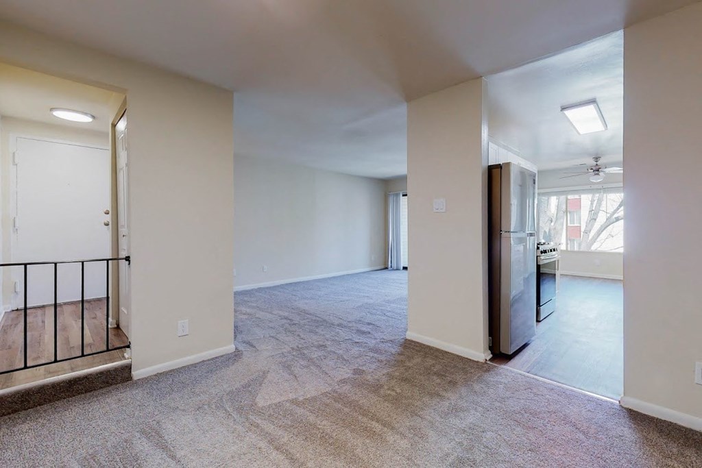 a renovated living room with a kitchen and a staircase