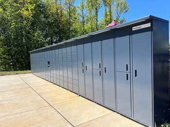 a metal building with its doors closed on a sidewalk