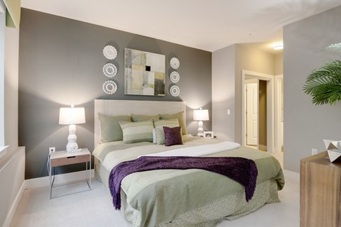 a bedroom with a bed and a mirror on the wall