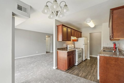 A kitchen with brown cabinets and white appliances.