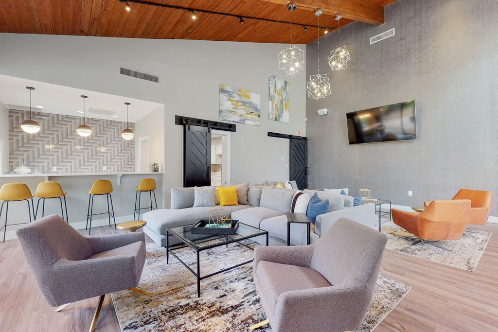 a living room with couches and chairs and a table