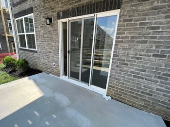 a brick house with a patio and glass doors
