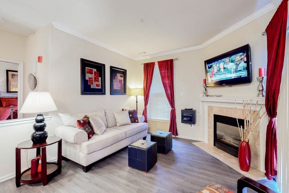 a living room with a white couch and a television