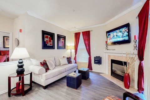 a living room with a white couch and a television