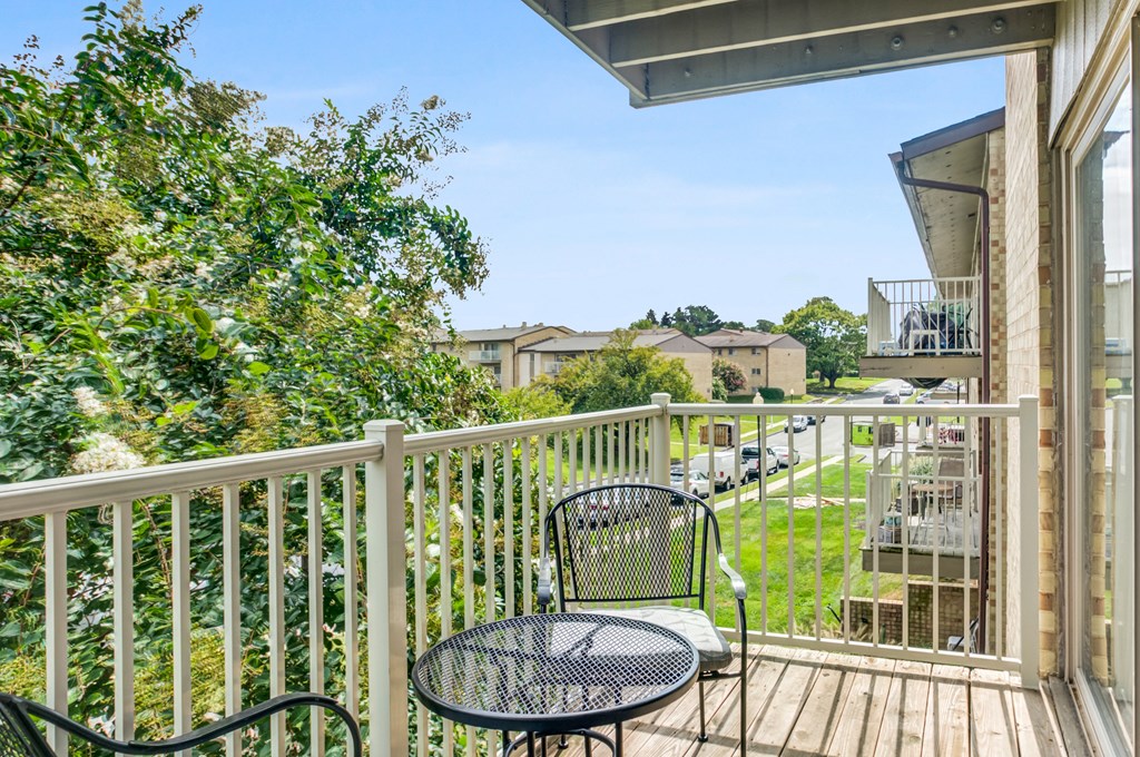 a deck with a chair and a table on it