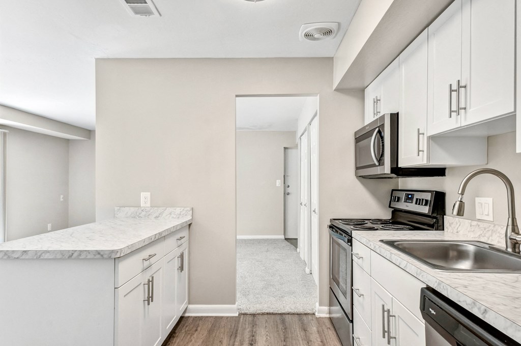 the preserve at ballantyne commons apartment kitchen with white cabinets and stainless steel appliances