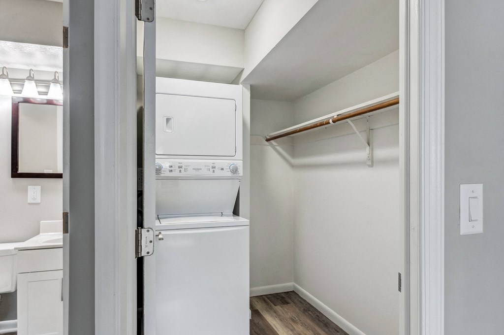 a white washer and dryer in a room with a white door