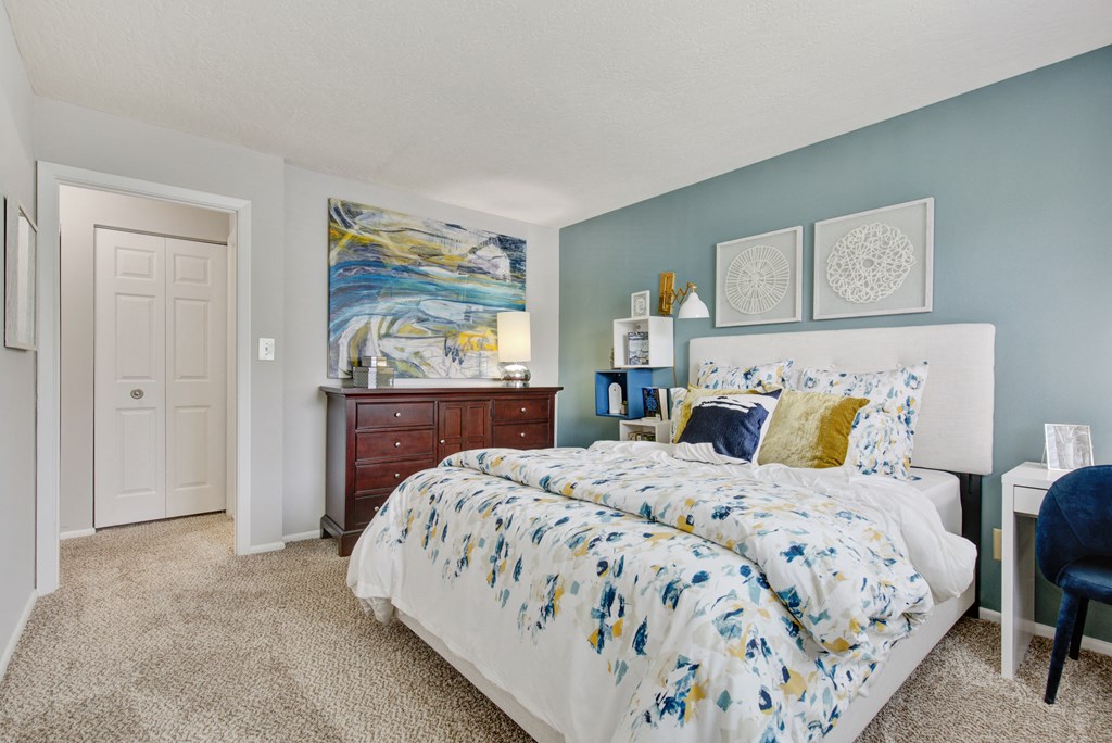 a bedroom with blue and white walls and a bed