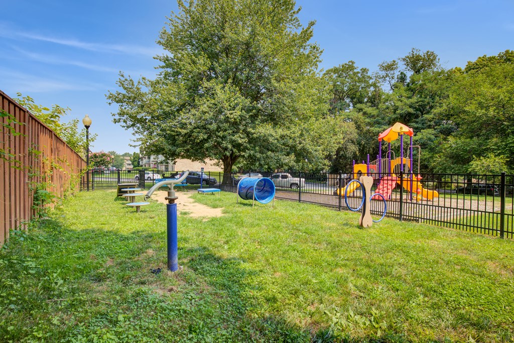 a playground with a swing set and slides in a park