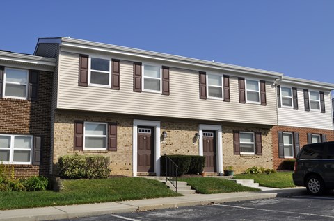 A row of houses with brown and beige siding.