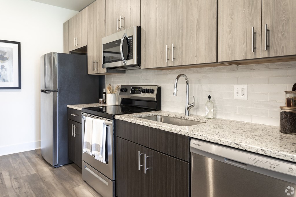 a kitchen with stainless steel appliances and a granite counter top