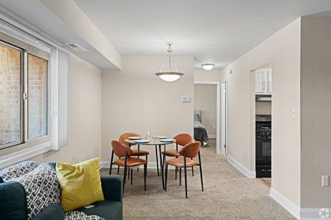 A dining room with a table set for four.