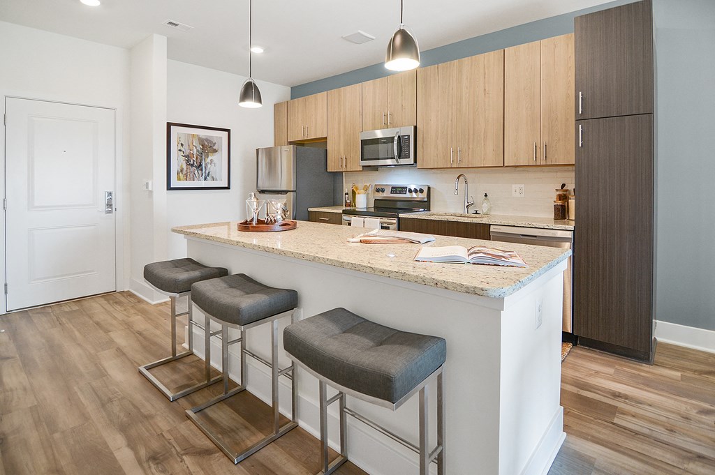 a kitchen with an island and three stools