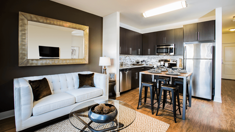 a living room and kitchen with a couch and a table