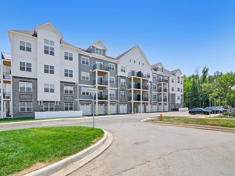 an empty street in front of an apartment building