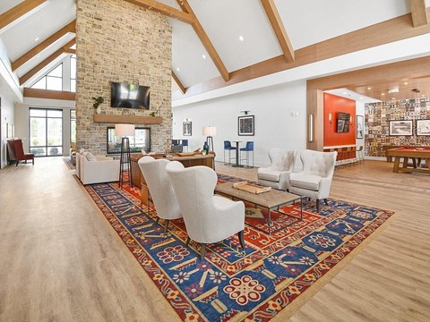 a large living room with a fireplace and a rug