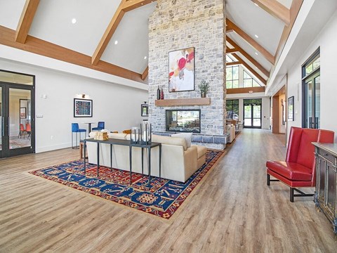 a living room with a fireplace and a rug