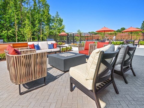 a patio with chairs and tables and umbrellas