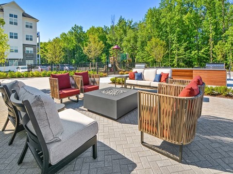 a patio with furniture and a fire pit