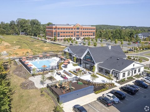 an aerial view of a resort with a swimming pool    and a building