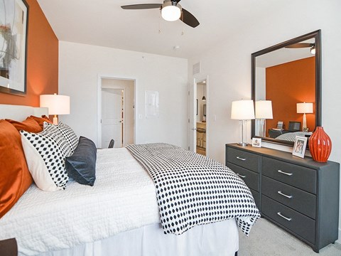 a bedroom with a large bed and a mirror