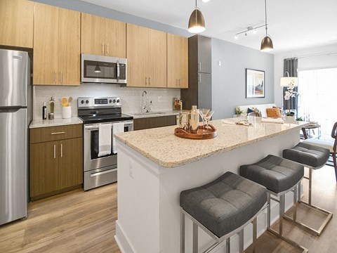 a kitchen with an island and stools in a house