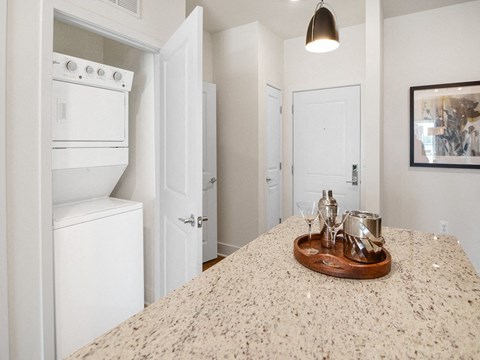 a kitchen with white appliances and a counter top