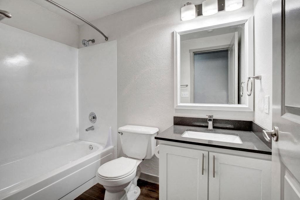 a bathroom with a toilet sink and bathtub