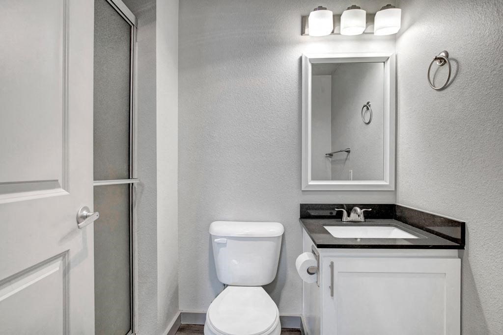 a bathroom with a toilet sink and shower